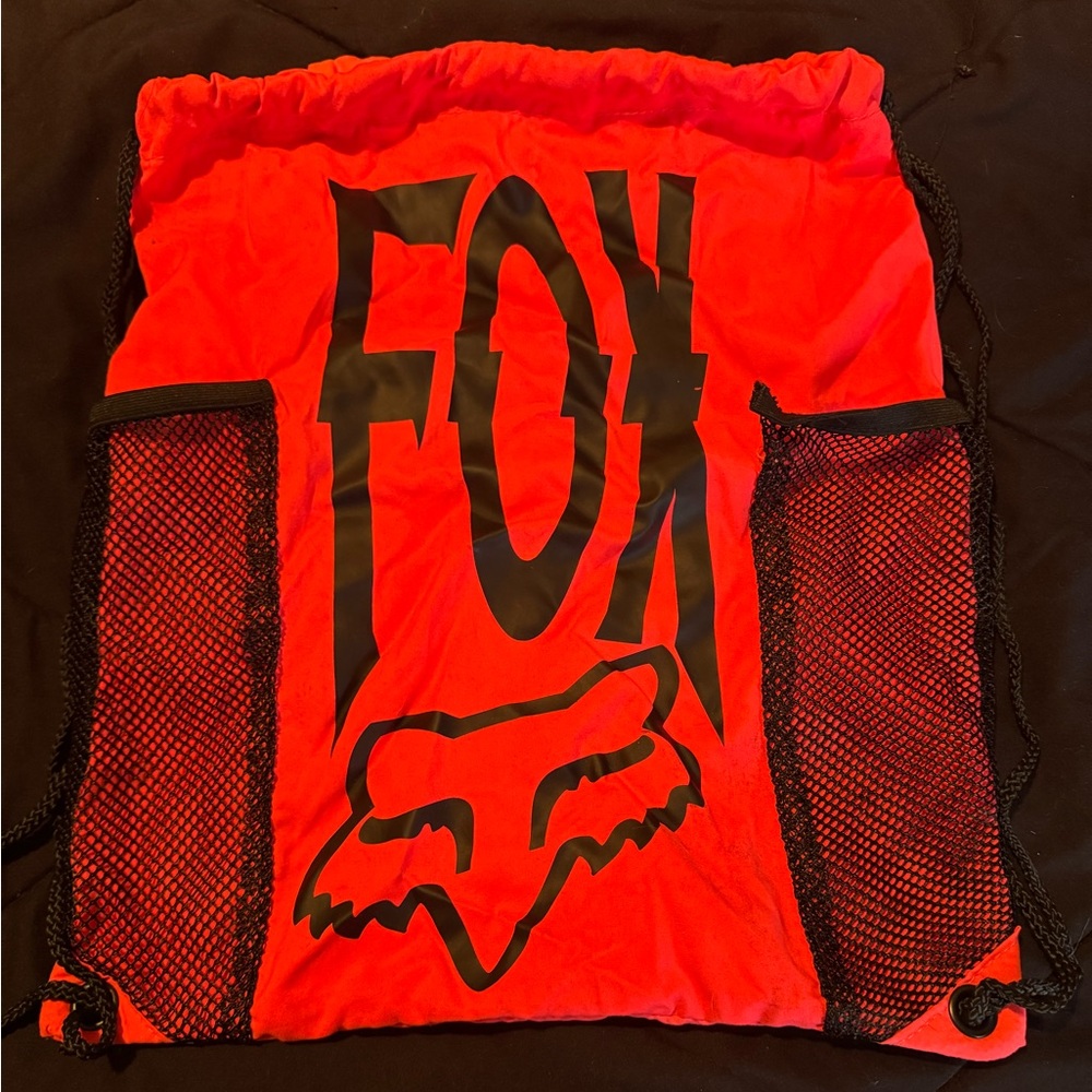 Fox brand drawstring bag. Orange color. Small tear in side pocket as shown.